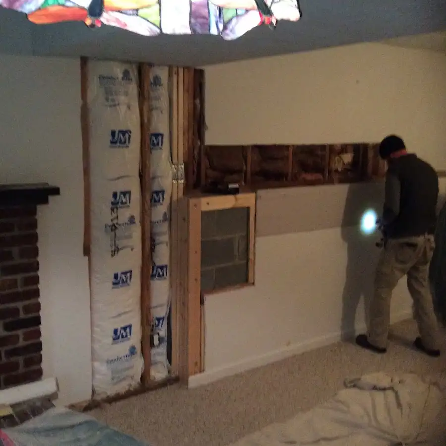 Restoration technician inspecting water damage in Waipahu